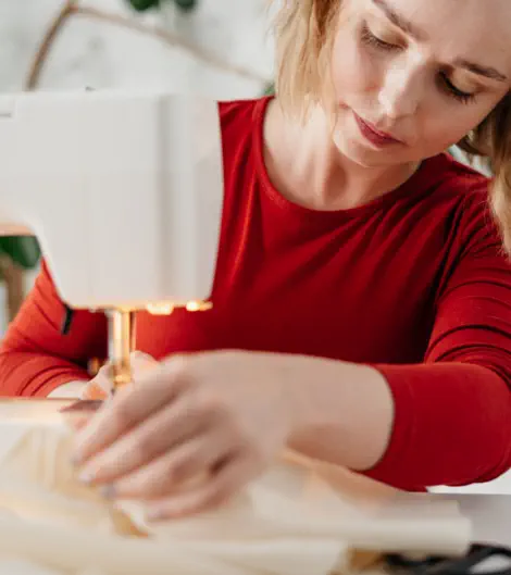 at the machine sewing a garment-michele's alterations